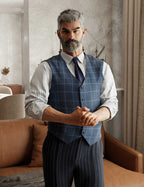 Full-body promotional render of a distinguished silver-haired Genesis 9 Male character wearing a blue windowpane waistcoat over a striped dress shirt with a navy tie and dark pinstripe trousers, set in a bright contemporary living space.