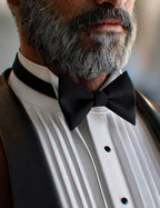 Close-up of Genesis 9 male tuxedo bow tie, pleated shirt, black buttons, and realistic beard detail
