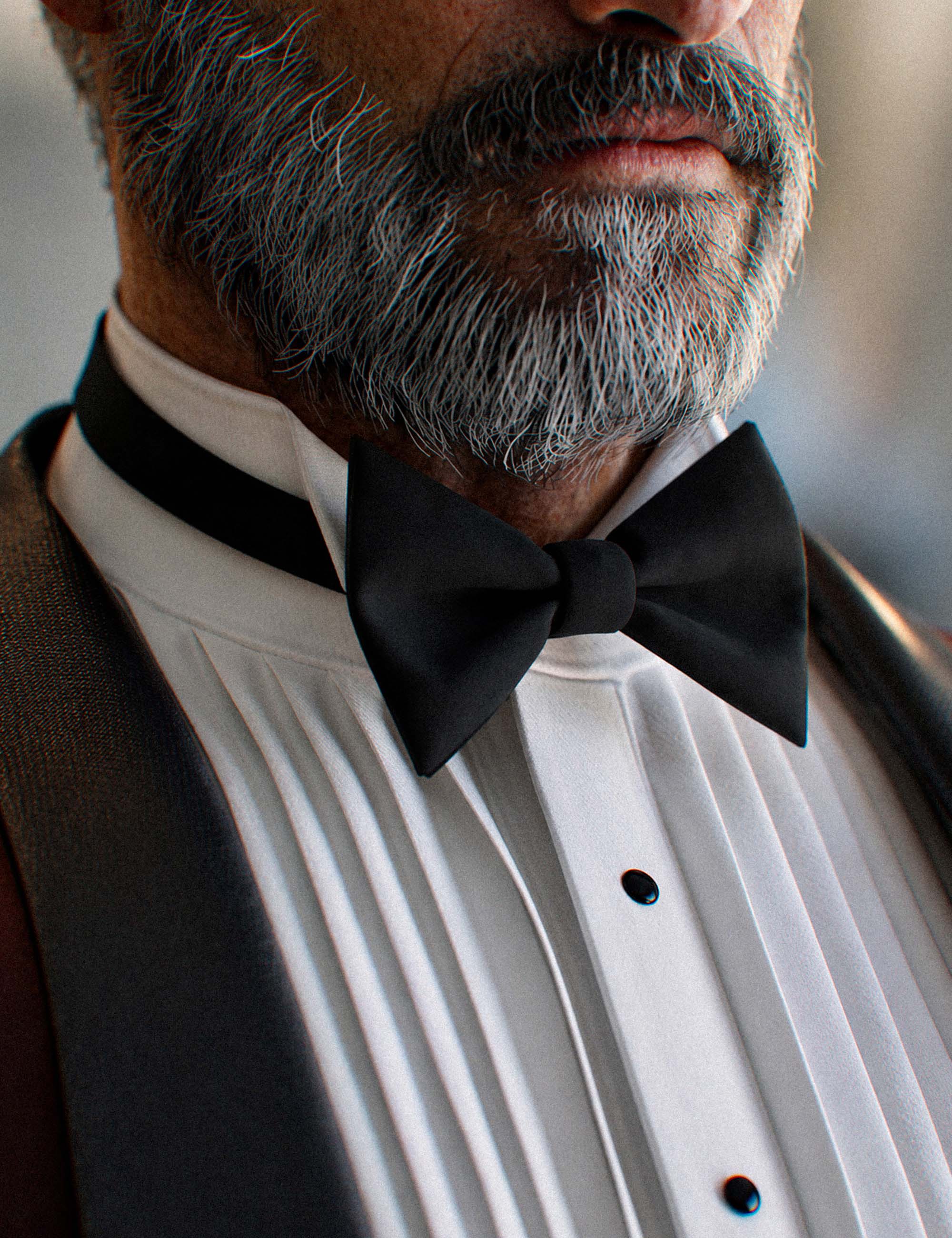 Close-up of Genesis 9 male tuxedo bow tie, pleated shirt, black buttons, and realistic beard detail