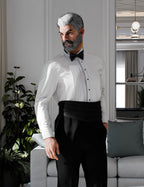Genesis 9 male character wearing formal tuxedo shirt, black cummerbund, and black tuxedo pants in luxury interior