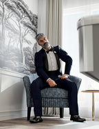 Genesis 9 male character seated in navy tuxedo with black lapels, bow tie, cummerbund, and formal shoes